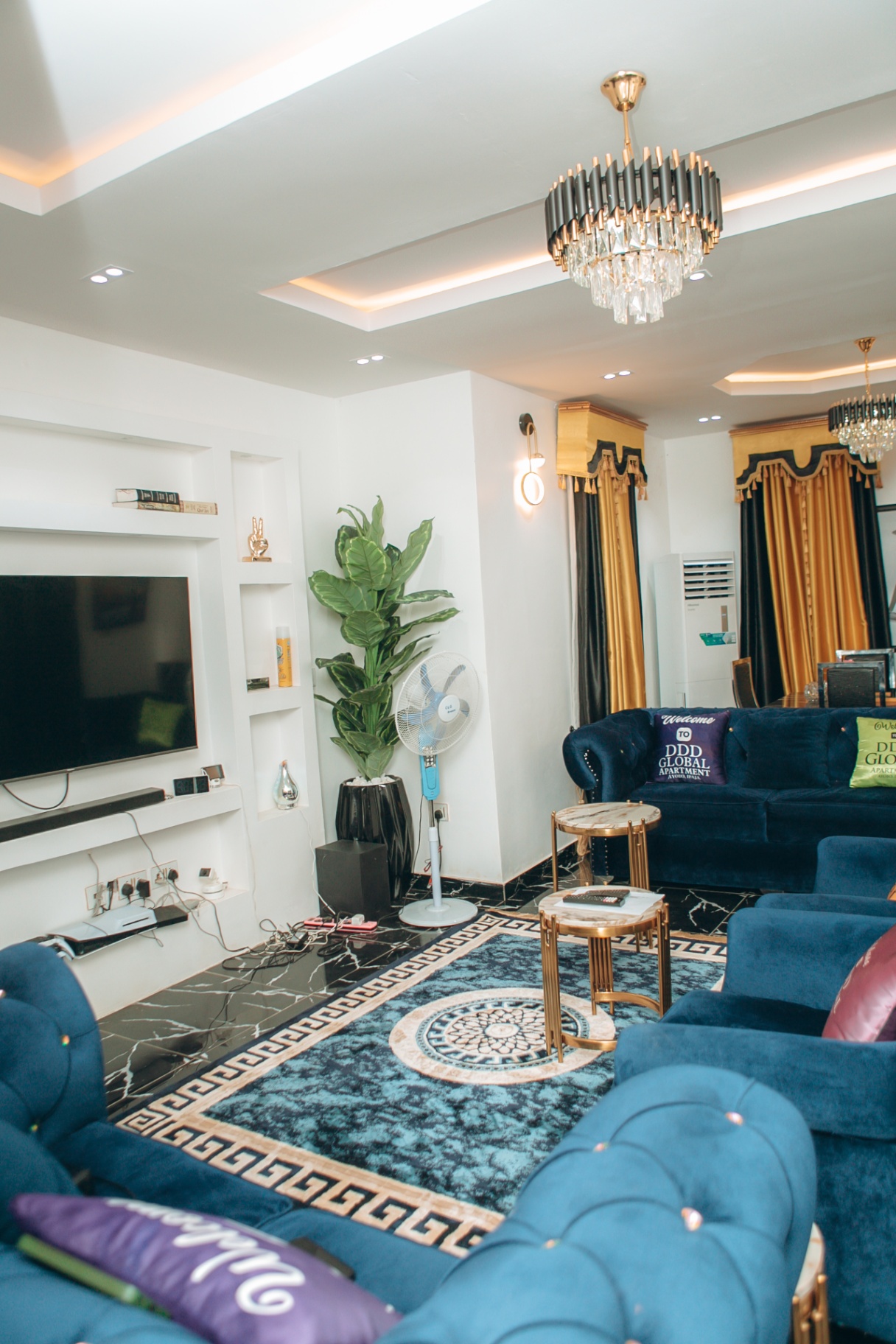 Spacious DDD Global Apartments living room with blue seating